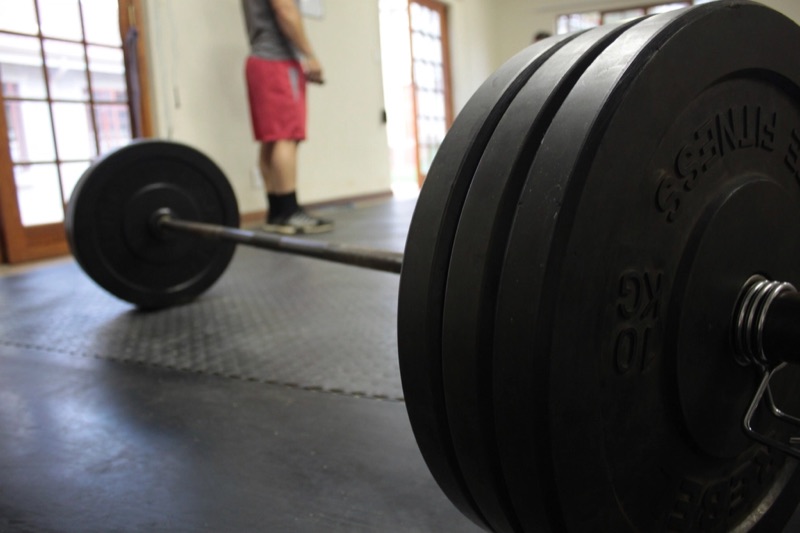 Loaded barbell resting on the gym floor